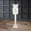 Capture Your Spin The Eclipse - DSLR Flash Photo Booth in white stands elegantly against a dark paneled wall, its sleek design highlighted by the rich wood floor beneath.