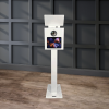 Capture Your Spin The Eclipse - DSLR Flash Photo Booth in white stands elegantly on a wooden floor, set against a dark gray paneled wall.